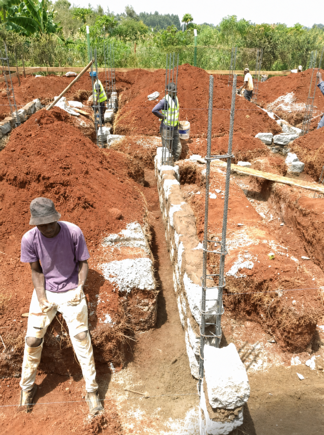 Construction team working on foundation trenches and reinforcement in Bungoma County