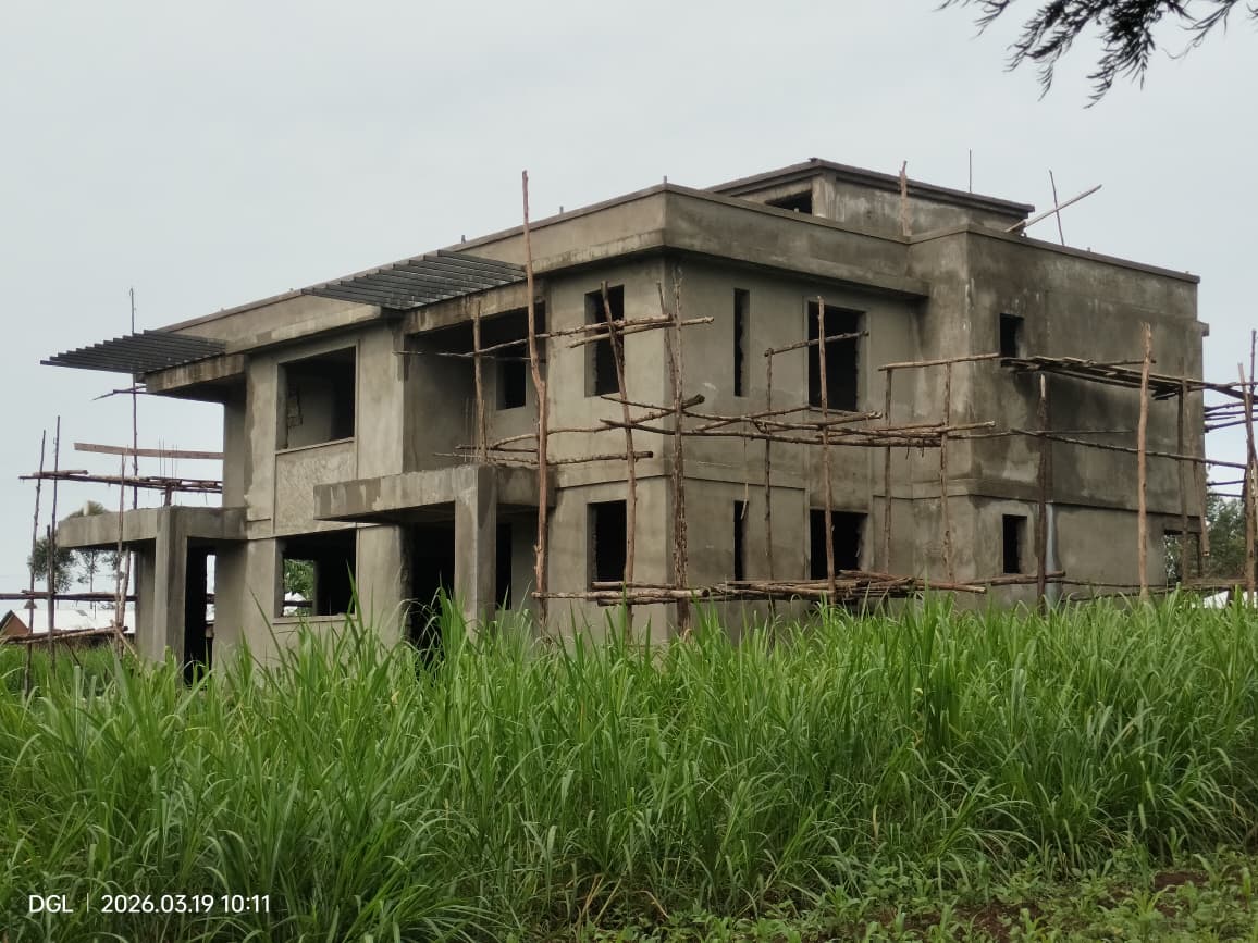 Multi-storey residential building under construction with exterior plastering underway
